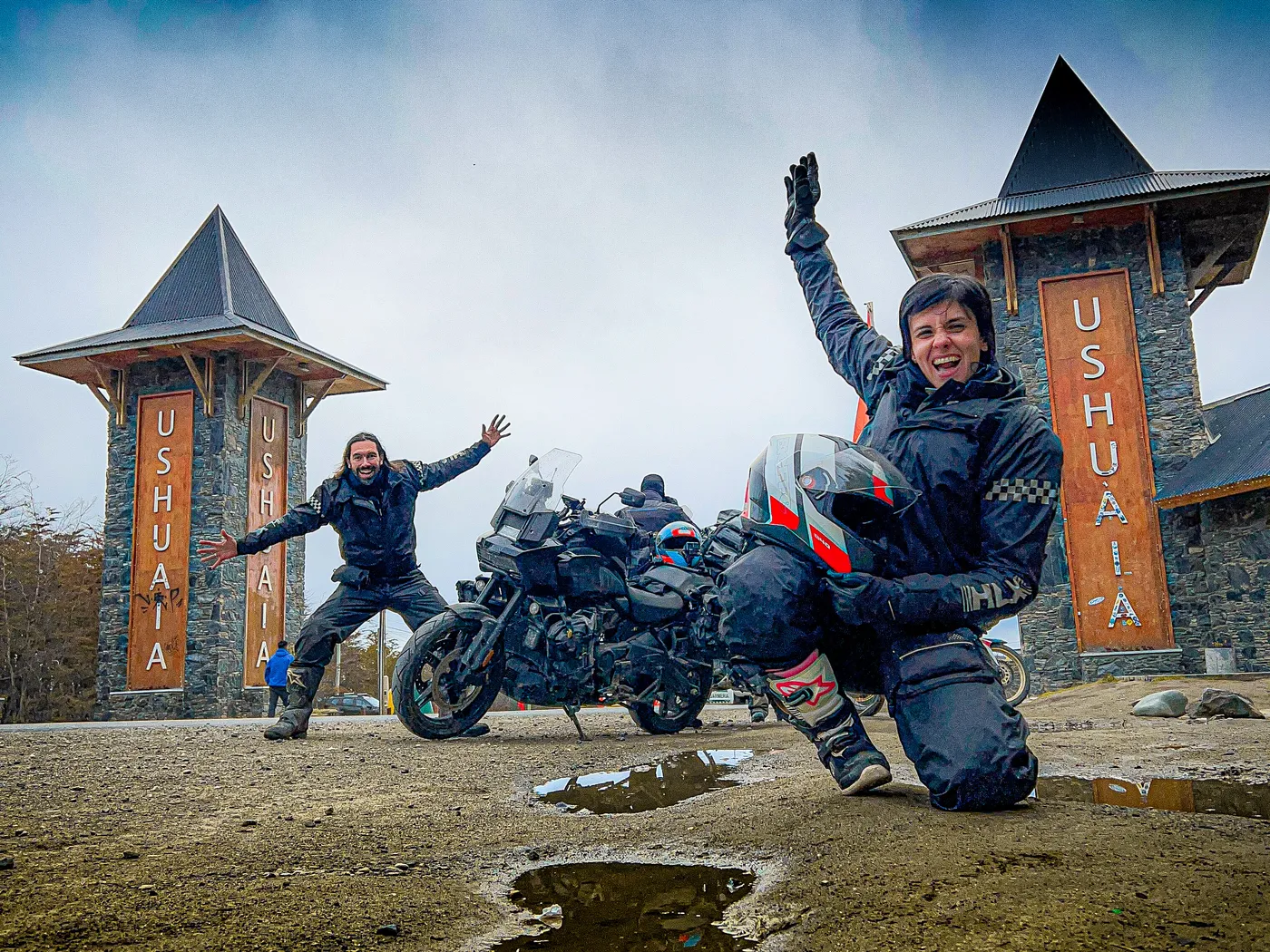 Ton e Nay comemorando com a moto no portal de Ushuaia